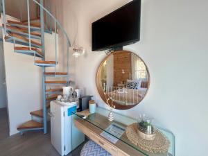a living room with a glass table and a mirror at Sea and Sand Elafonisos in Elafonisos