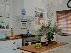 a kitchen with a table with a bowl of apples on it at The Gregoire Boutique Villa in Hermanus