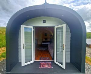 an open door of a tiny house with a bedroom at The Star Inn in Dylife