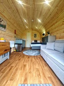 a living room with a couch and a bed at The Star Inn in Dylife