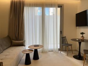 a living room with a couch and a table at House 29 Suites in Heraklio