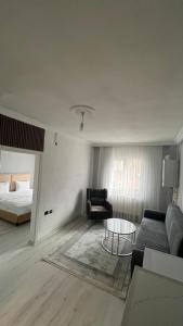 a living room with a couch and a bed at Divan Kars Suit in Kars