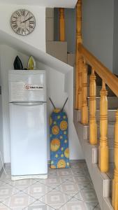 a white refrigerator next to a staircase with a clock at Noclegi U Renaty Solina in Solina