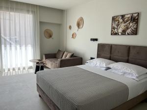 a bedroom with a large bed and a couch at House 29 Suites in Heraklio