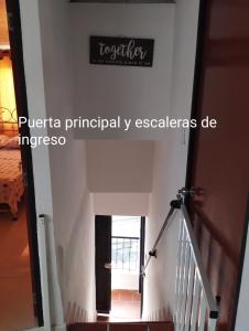 a staircase in a house with a sign on the wall at Apartamento con vista a la ciudad en barrio campo hermoso 301 in Bucaramanga
