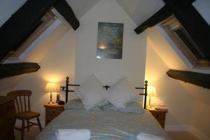 a bedroom with a bed and a poster on the wall at Half-pint Cottage in Stroud