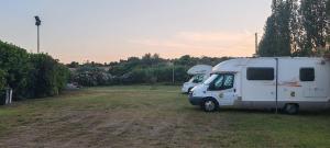 two rvs parked in a field next to each other at Villa Cilento Parking e Sosta Camper in Capaccio-Paestum