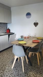 a dining room with a wooden table and chairs at Appartement Randogne avec grande terrasse in Crans-Montana