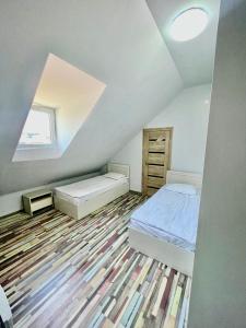 a attic bedroom with a bed and a window at Hayq in Yerevan