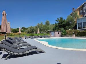 a row of lounge chairs next to a swimming pool at Apartments Šeherzada in Pula