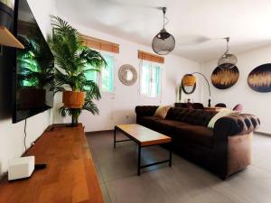 a living room with a couch and a plant at Chill and Beach in Torremolinos