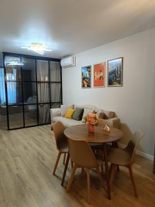 a living room with a couch and a table at Rainbow Residence Batumi in Batumi