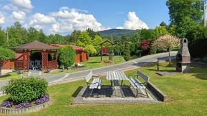 a park with a bench and a gazebo at Noclegi U Renaty Solina in Solina