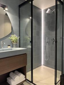 a bathroom with a shower and a sink at House 29 Suites in Heraklio +58 photos