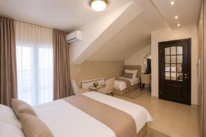 a hotel room with a bed and a living room at Hotel Bajadera Lux in Belgrade