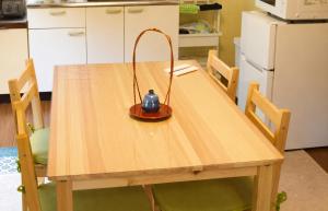 a lamp sitting on a wooden table in a kitchen at Komorebi/こもれび in Takayama