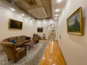 a living room with a couch and a table at Azcot Nizami Hotel in Baku