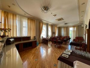 a large room with tables and chairs in it at Azcot Nizami Hotel in Baku