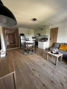 a living room with a couch and a table at Apartament Eden in Srebrna Góra