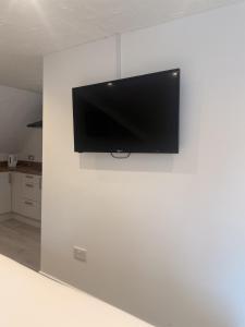 a flat screen tv hanging on a white wall at Star Studios in Southampton