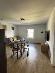 a living room with a table and chairs and a couch at Apartament Eden in Srebrna Góra