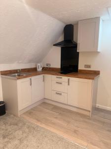 a kitchen with white cabinets and a sink at Star Studios in Southampton +8 photos