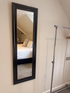 a mirror on a wall next to a bed at Star Studios in Southampton