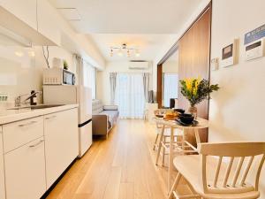 a kitchen and a living room with a table at u-heim Osaka Tengachaya in Osaka