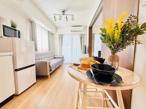 a kitchen and living room with a table with food on it at u-heim Osaka Tengachaya in Osaka