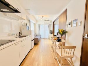 a kitchen and dining room with a table and chairs at u-heim Osaka Tengachaya in Osaka