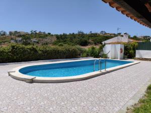 a swimming pool in the middle of a yard at Porto Monte in Maceira