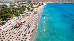an aerial view of a beach with umbrellas and the ocean at Boutique Sea & Garden in Vari