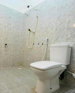 a bathroom with a toilet and a shower at Pearl Resort in Arugam Bay