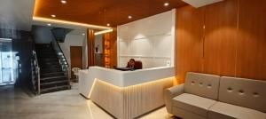 a person sitting at a reception desk in a room at Hotel bharti international in Raipur