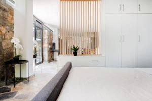 a bedroom with white walls and a large window at Lemon Tree Villa in Chalkida