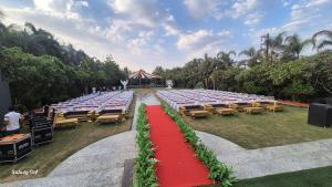 a row of tables and chairs with a red carpet at Star resort in Bhusāwal +2 photos