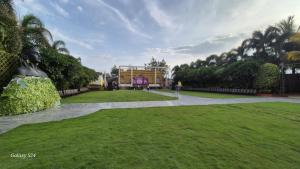 a person standing in the middle of a park at Star resort in Bhusāwal