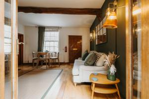 a living room with a white couch and a table at Wenlock's Cosy Cottage in Much Wenlock