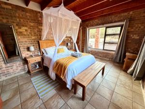 a bedroom with a bed with a canopy at Nghala Self-catering Holiday Home in Marloth Park +19 photos