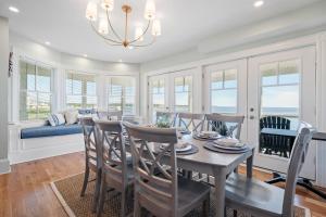 a dining room with a table and chairs at Luxury York Oceanfront Nubble Views in York
