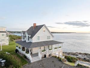 an aerial view of a white house with the ocean at Luxury York Oceanfront Nubble Views in York