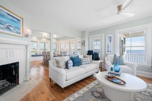 a living room with a white couch and a fireplace at Luxury York Oceanfront Nubble Views in York