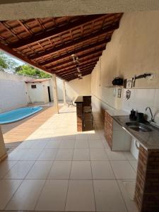 a kitchen with a sink and a swimming pool at CASA para TEMPORADA in Barra do Garças