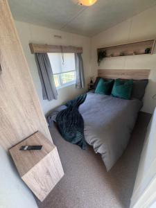 a bedroom with a bed in a tiny house at Haighs caravan hire in Rhyl