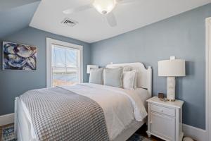 a bedroom with a bed and a ceiling fan at Luxury York Oceanfront Nubble Views in York