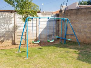an empty swing set in a yard at 5@Partridge Guesthouse in Newcastle +6 photos