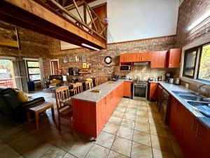 a kitchen with red cabinets and a counter top at Nghala Self-catering Holiday Home in Marloth Park