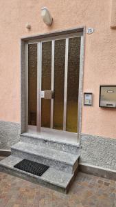 a glass door on the side of a building at Casa Pino Malè in Malè
