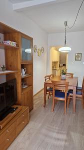 a living room with a table and a dining room at Casa Pino Malè in Malè
