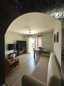 a living room with a couch and a table at Mollys apartment 1 in Pogradec